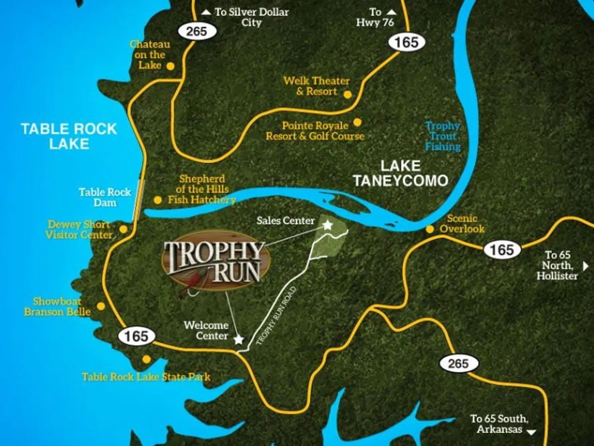 This exterior image showcases a sign for Trophy Run and Table Rock Lake, along with the Welcome and Sales Centers, surrounded by lush greenery and lake views. It captures the area's proximity to Table Rock Lake and hints at the variety of activities available nearby, including boating, hiking, and fishing.