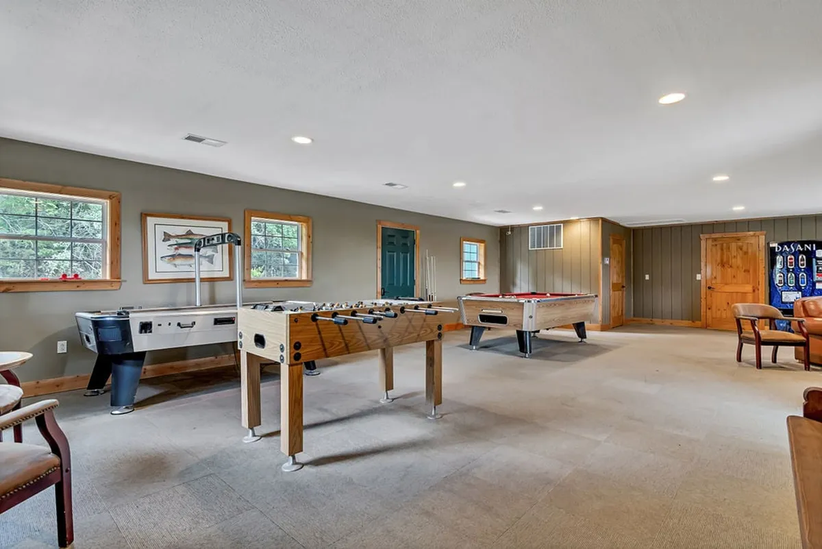 This interior shot features a lively games lounge with a foosball table, pool table, and comfortable seating area. The space is designed for fun, socializing, and friendly competition, making it ideal for families and groups seeking entertainment indoors.